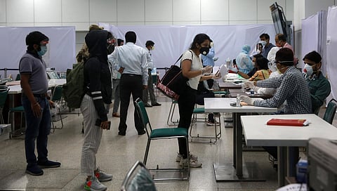 A health worker screens an passenger who arrived from Singapore at the Indira Gandhi international airport T3 during the nationwide lockdown. (Photo | Shekhar Yadav, EPS)