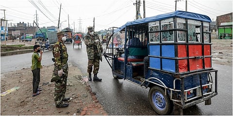 Security personnel stop a motorist at a checkpoint along a road during a government-imposed lockdown as a preventive measure against the COVID-19 coronavirus, in Dhaka on May 1, 2020. (Photo | AFP)