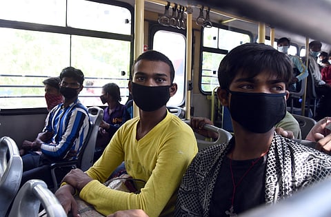 Stranded migrant workers from Bihar state board a bus for a railway station to return back to theit homes during a goverment-imposed nationwide lockdown as a preventive measure against the COVID-19. (Photo | Parveen Negi, EPS)