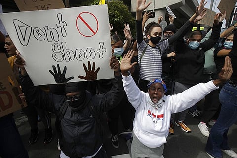 People yell while kneeling in San Francisco, Sunday, May 31, 2020, at protests over the Memorial Day death of George Floyd. Floyd was a black man who was killed in police custody in Minneapolis on May 25. (Photo | AP)