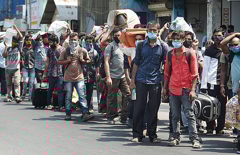 Migrants walk towards Chennai Central Railway Station to board Shramik train during the ongoing nationwide lockdown in Chennai on May 30 2020. (Photo | PTI)