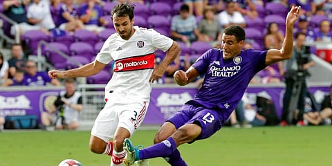 Orlando City’s Tesho Akindele (13) attempts to get the ball past Chicago Fire’s Jonathan Bornstein (3) during the first half of an MLS soccer match, Sunday, Oct. 6, 2019, in Orlando. (Photo | AP)