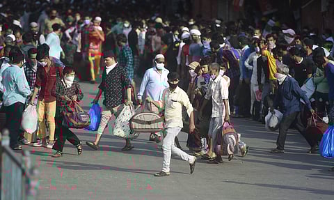 Migrants gather outside Dharavi slums to take buses to reach a railway station in Mumbai (File photo | PTI)