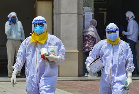 Medics take samples of suspected COVID-19 patients for lab test at a government hospital. (Photo | PTI)