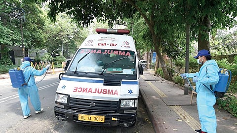 Municipal workers sanitise an ambulance as part of an NDMC campaign in Delhi. (Photo | EPS)