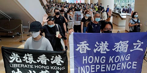Protesters hold flags in a shopping mall during a protest in Hong Kong, Friday, June 12, 2020. (Photo | AP)