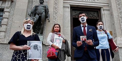 From left, Laura Capella, Nicoletta Bosica, Stefano Fusco and Arianna Dalba holds pictures of their relatives, victims of COVID-19, as they stand in front of Bergamo's court, Italy, Wednesday, June 10, 2020. (Photo | AP)