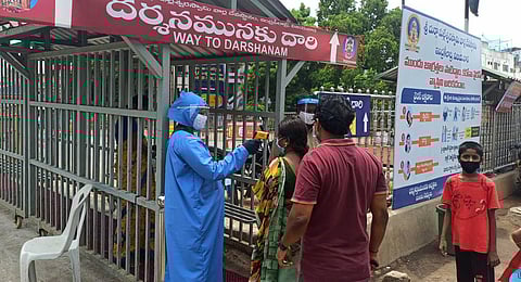 Devotees undergoing thermal screening at Kanaka Durga temple in Vijayawada. (Photo | P Ravindra Babu, EPS)