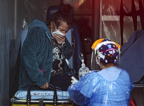 A patient with respiratory distress receives aid from a medical worker wearing protective gear as a precaution against the new coronavirus, in the emergency area of the San Jose hospital in Santiago, Chile, Friday, June 12, 2020. (Photo | AP)