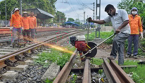 Labourers resume routine maintenance work on a railway track during the ongoing COVID-19 lockdown near Santipur railway station in Nadia Saturday June 13 2020. (Photo | PTI)