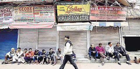 Traders sit outside closed shops at Chandni Chowk (Photo | Naveen Kumar, EPS)
