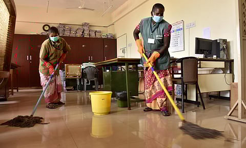 Sanitary worker cleaning inside the Coimbatore Collectorate following the Goverment Order to sanitise and clean all goverment buildings on Second saturday of a month which is a holiday for Goverment Employess. (Photo | U Rakesh Kumar/EPS)