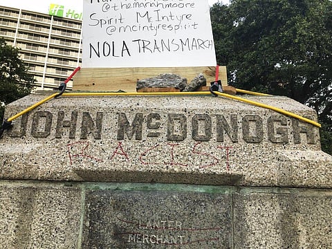 The word 'racist' is scrawled in red under the name of John McDonogh on a pedestal in Duncan Plaza in New Orleans, Saturday. (Photo | AP)