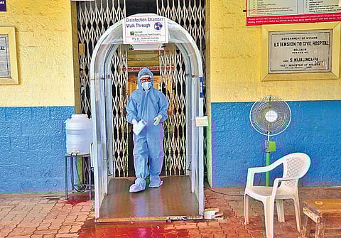 A doctor working at BIMS Hospital in Belagavi walks through a disinfectant tunnel after attending to patients in the Covid-19 ward, on Saturday | Ashishkrishna HP