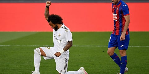Real Madrid's Brazilian defender Marcelo kneels on the field to celebrate his goal during the Spanish League football match against Eibar. (Photo | AFP)