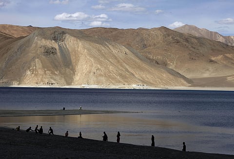 People stand by the banks of the Pangong Lake, near the India-China border in Ladakh (File Photo | AP)