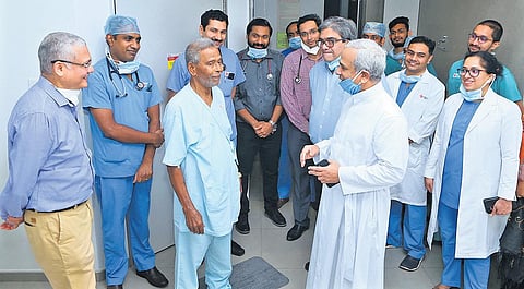 After the successful surgery, the patient being greeted by Fr Johnson Vazhappilly CMI, executive director and CEO, Rajagiri Hospital, in the presence of a team of doctors | Express