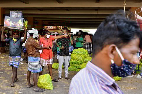 The makeshift fruit market at Madhavaram Mofussil Bus Terminus seen a huge rush as traders and retailers throng for business after state government announced a 12 day long complete lockdown in Tamil Nadu. (PHOTO | DEBADATTA MALLICK, EPS)