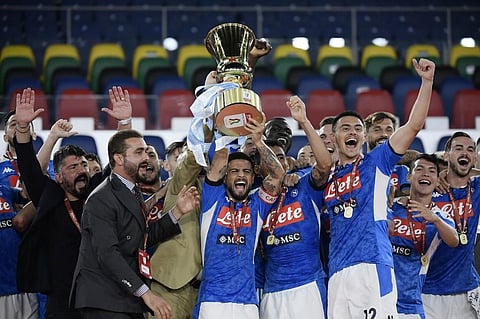 Napoli's Italian forward Lorenzo Insigne (C holding trophy), Napoli's Italian head coach Gennaro Gattuso (L) and players celebrate after winning the TIM Italian Cup (Coppa Italia) final football match Napoli vs Juventus. (Photo | AFP)