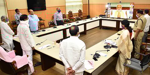 Telangana CM K Chandrasekhar Rao stands in solidarity with other state officials as PM Narendra Modi holds pays a tribute to the martyrs. (Photo| EPS)