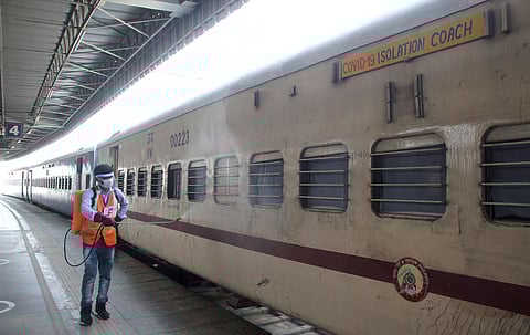 A sanitaion staffer spray disinfectant at Covid -19 Isolation Coaches at Anand Vihar railway station in Delhi as Covid-19 Isolation caches parked at Anand Vihar Railway Station in Delhi. (Photo | Anil Shakya, EPS)