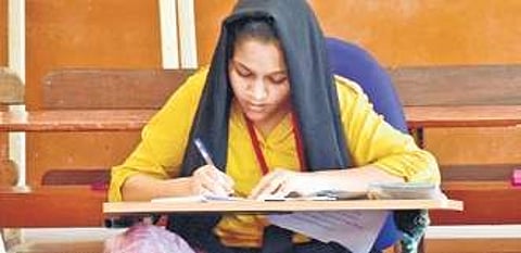 Image of a student writing second PUC exams used for representational purpose.