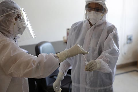 Medical personnel at a Covid screening centre go through a test procedure in Vasant Gaon in New Delhi on Thursday. (Photo | Shekhar Yadav/EPS)