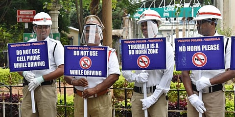 Traffic police hold placards as part of anti-noise awareness campaign at Tirumala on Thursday. (Photo| EPS)