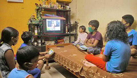 A group of students watching Victers channel at Rajaji Nagar in Thiruvananthapuram on Monday as the new academic year began online as well as on the TV channel | B P Deepu