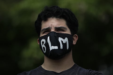 A demonstrator wears a mask with 'BLM' written on it, the letters referring to 'Black Lives Matter,' during a protest over the death of George Floyd. (Photo | AP)