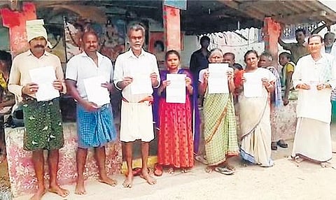 Farmers showing the bank notices in Srikakulam on Monday. (Photo | EPS)