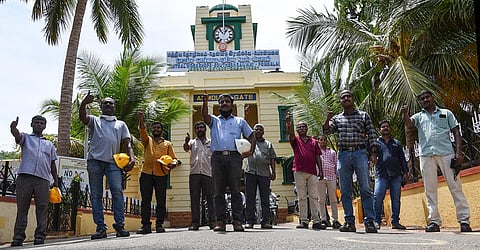 Golden Rock Railway workshop team that repaired the clocktower in District Court. The team is standing in front of century old clock tower in Golden Rock workshop in Tiruchy on Friday. (Photo | MK Ashok Kumar, EPS)