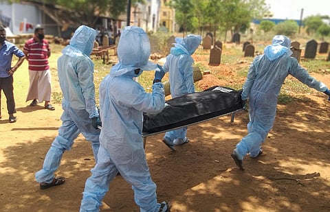Armed with PPE kits, TMMK members help families of deceased COVID patients by giving them a dignified burial. (Photo | EPS)