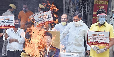 Members of Confederation of All India Traders burn Chinese goods during a protest in New Delhi. (Photo | Parveen Negi, EPS)