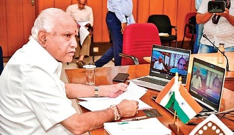 Chief Minister B S Yediyurappa chairs a meeting of his ministers and officials at his home office ‘Krishna’ in Bengaluru on Monday | Express