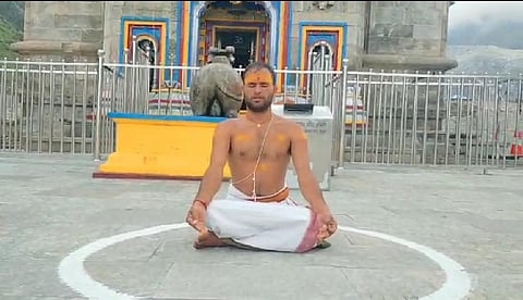 Sanotsh Trivedi sits outside Kedarnath temple draped in a single piece of dhoti. (Photo | Express)