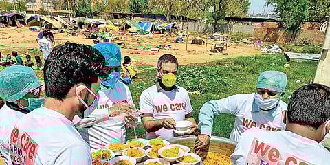 We Care volunteers distributing food.