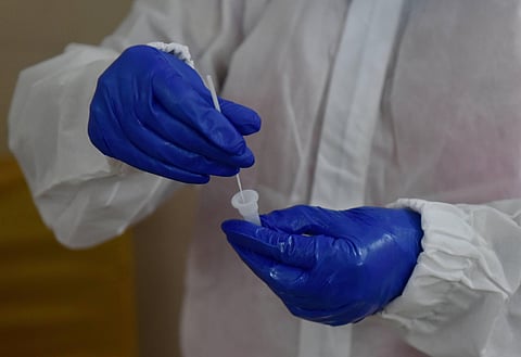 A medic collects samples via Rapid Antigen for COVID-19 test. (Photo | PTI)