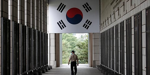A man wearing a face mask as a precaution against the new coronavirus, walks near the names of US and UN soldiers who were killed in the Korean War, at the War Memorial of Korea in Seoul. (Photo| AP)