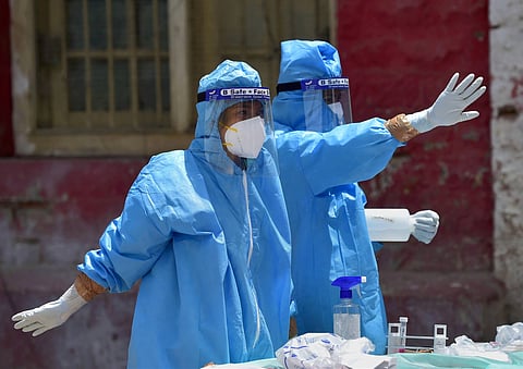 Medics wearing a PPE prepare to collect samples for COVID-19 tests in Bengaluru (Photo | PTI)
