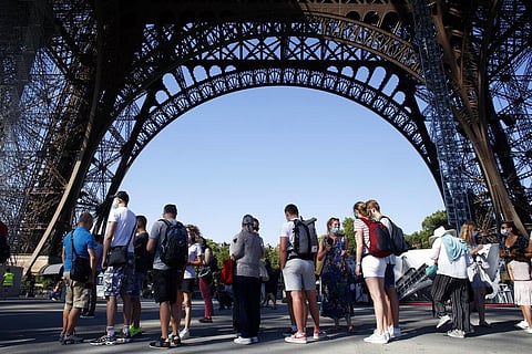 People queue up prior to visit the Eiffel Tower, in Paris, Thursday. (Photo | AP)