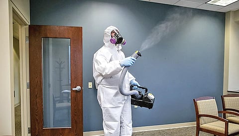 GermCops workers sanitising the interiors of a home and (inset) SilverPro masks by Lohia Health. (Photo| EPS)