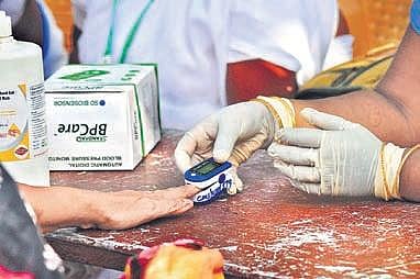 Officials conducting thermal screening and oximeter tests on residents of Kirlampudi Layout I EXPRESS