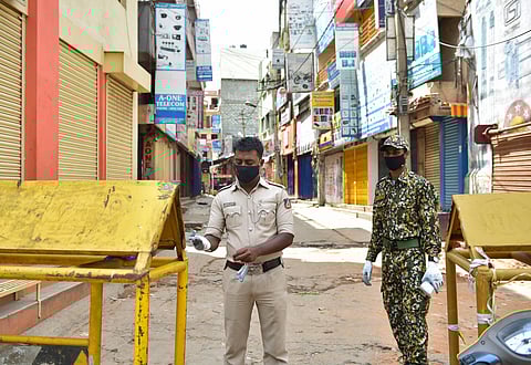 Bengaluru Police and BBMP personnel seal Sadar Patrappa road as the state government announced strict lockdown due to surge in COVID-19 cases in the area in Bengaluru Saturday June 27 2020. (Photo | PTI)