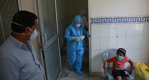A health official collects a swab sample from a child during the Government conduct rapid antigen COVID-19 tests at Lado sarai in New Delhi on Friday. (Photo | Shekhar Yadav/EPS)