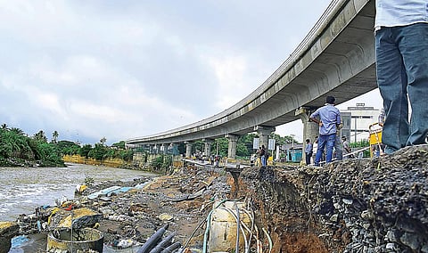 Curious onlookers at the collapsed retaining wall on Friday