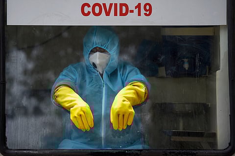 A man awaits people at a swab testing facility. (Photo| PTI)