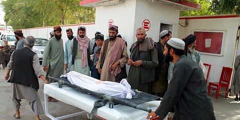 Afghans carry the body of a man who was killed during an attack, in the southern Helmand province. (Photo | AP)