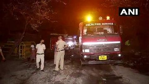 Delhi fire service personnel fight to douse the fire at Tughlaqabad slum in Delhi. (Photo | ANI)