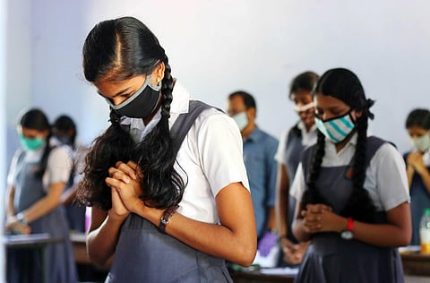 File photo of students offering prayer before receiving the question paper at the BEM Girls Higher Secondary School in Kozhikode. (Photo | T P Sooraj, EPS)